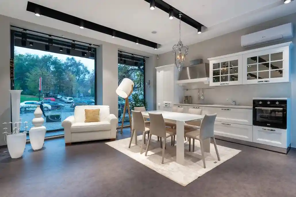 Modern kitchen featuring a white farmhouse sink, painted countertops, and a view to outdoor kitchen space